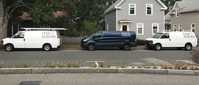 Three DT Painting & Services vans parked on a street