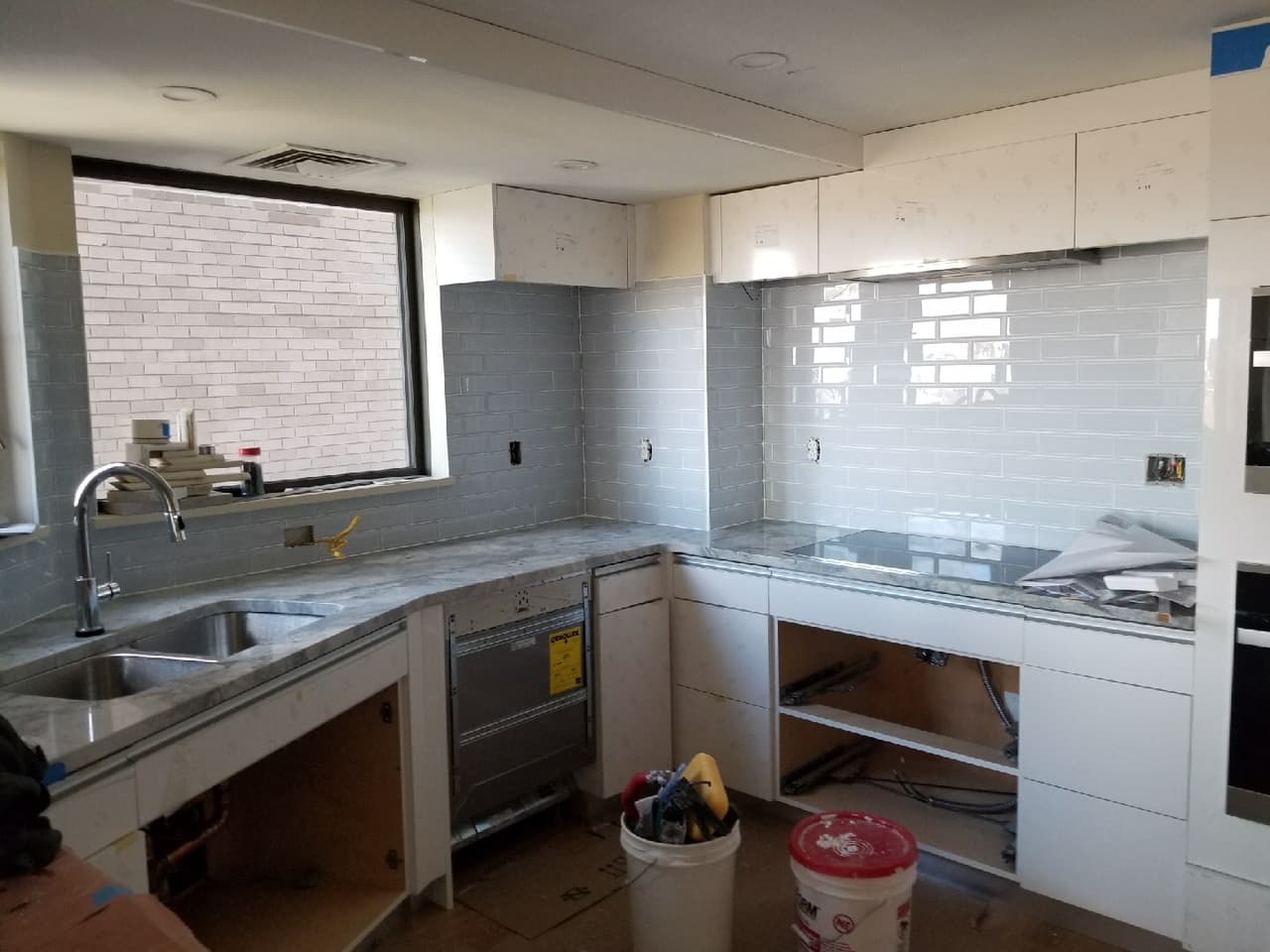 Kitchen remodel in progress with subway tile backsplash