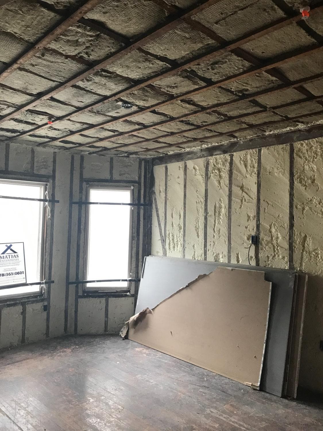 Room with insulation in the walls and drywall ready to hang