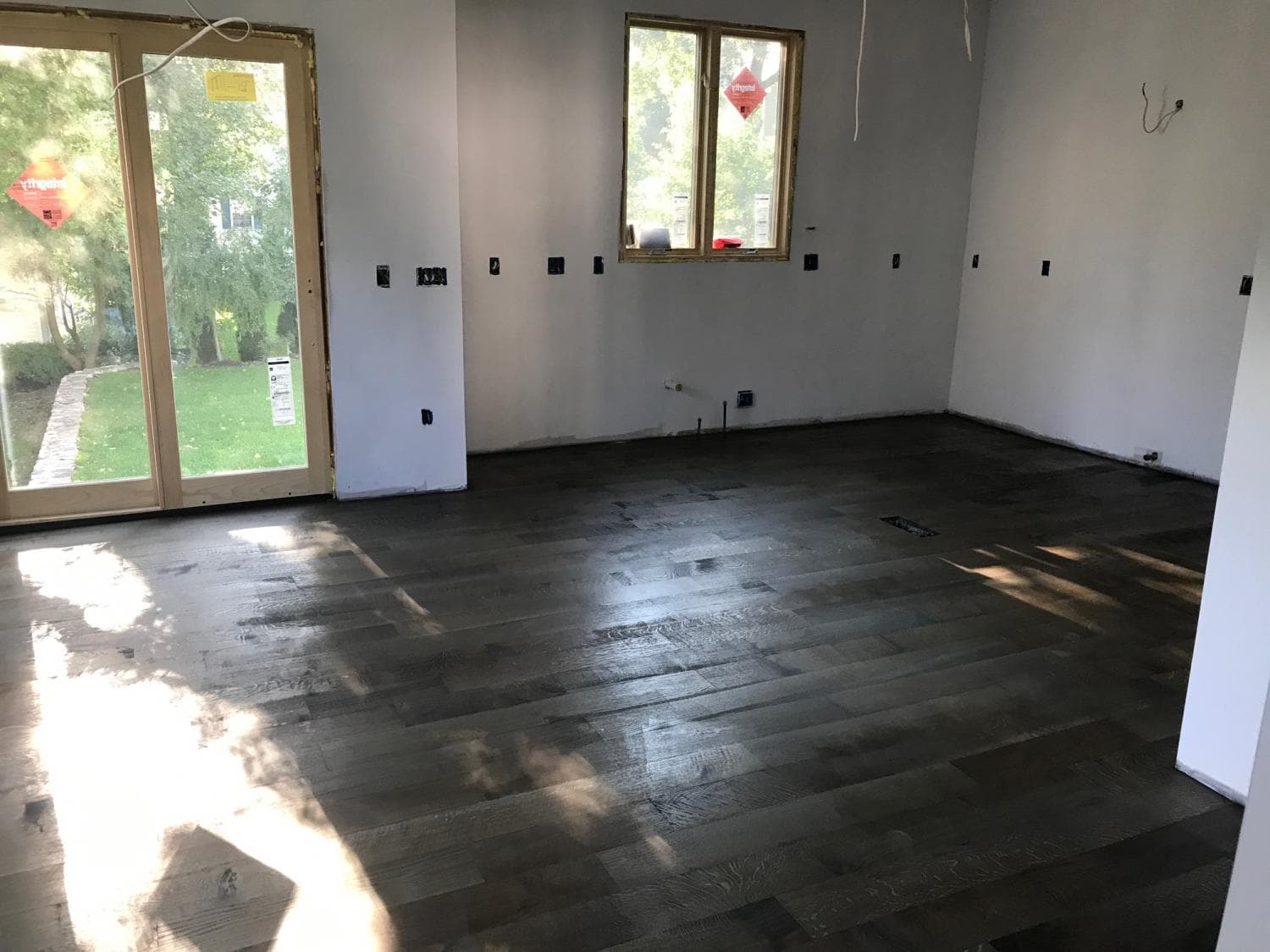 Empty room with new dark plank floors