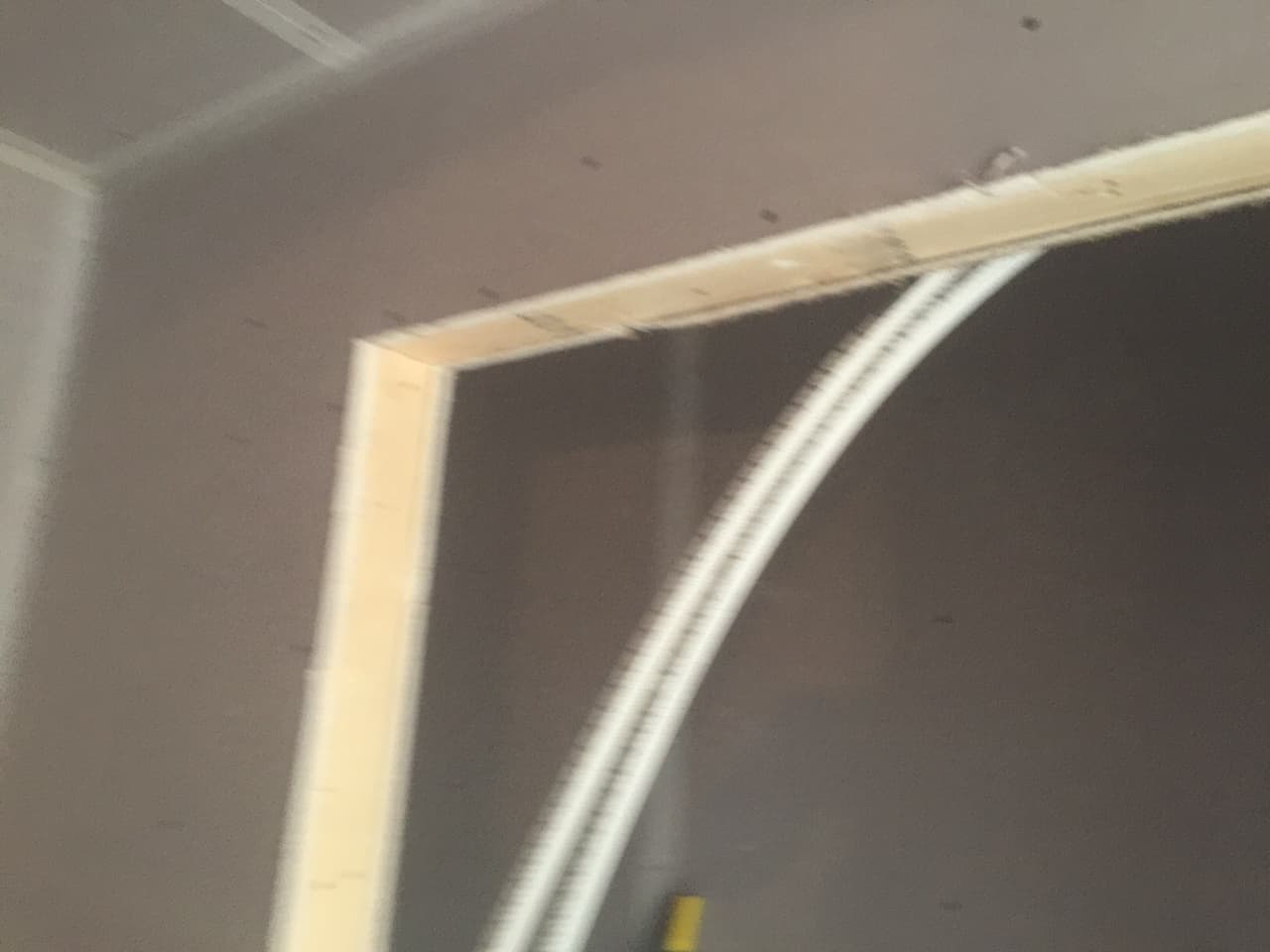 Arched doorway with new corner bead before paint