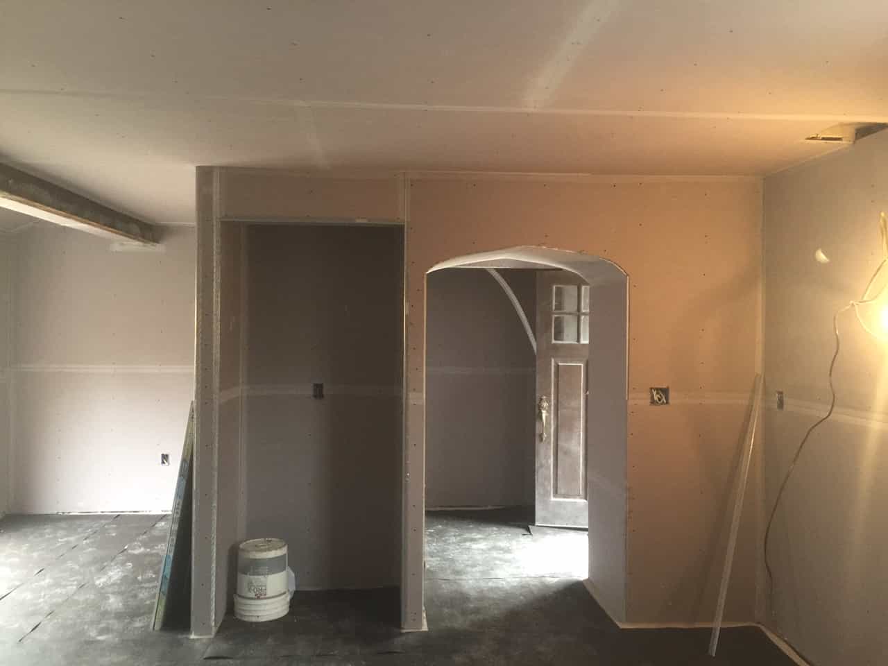 Freshly painted walls and arched doorway during a renovation