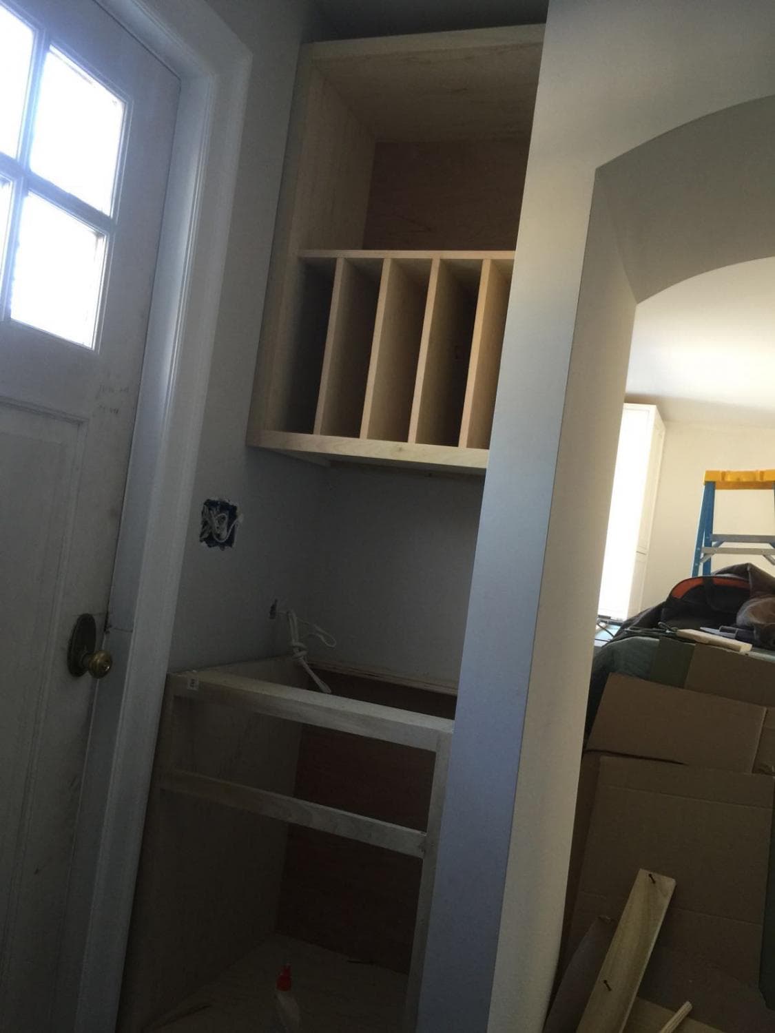 Built-in cubbies being installed next to a door