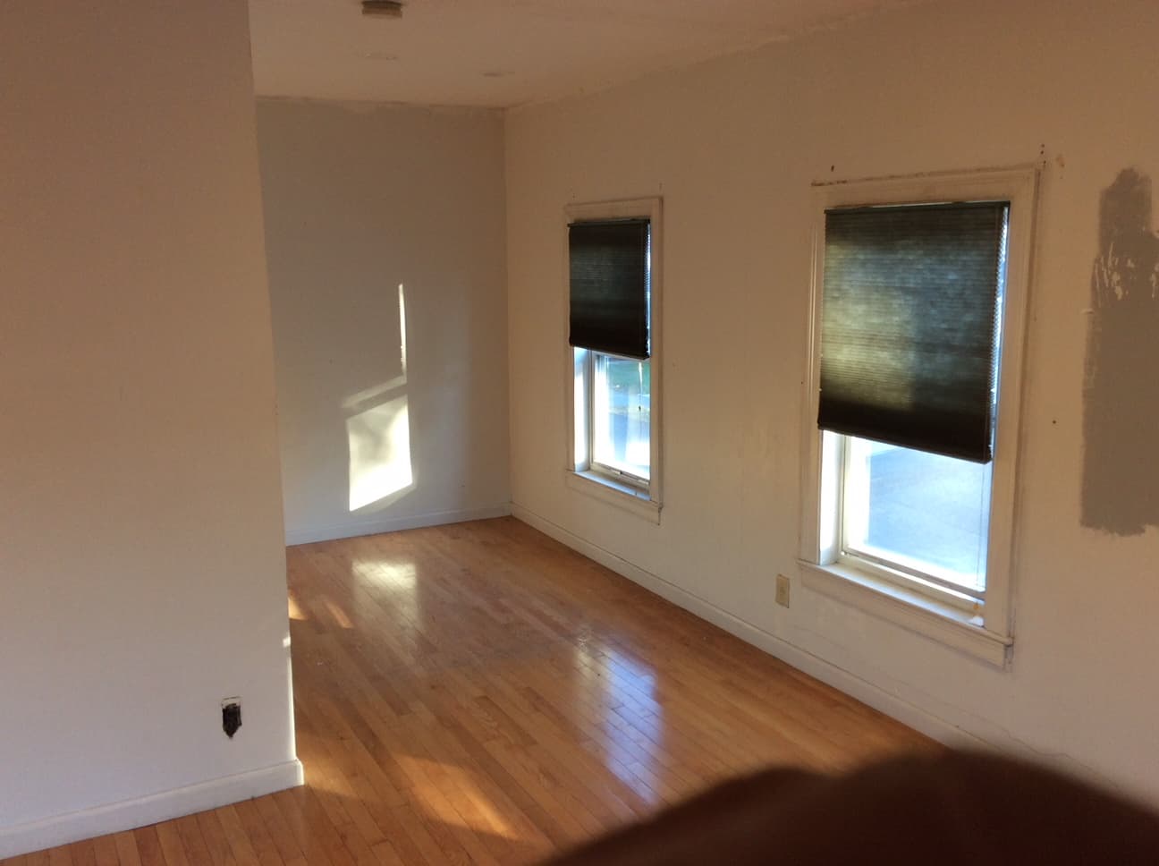 Empty bedroom with freshly painted walls and wood floors
