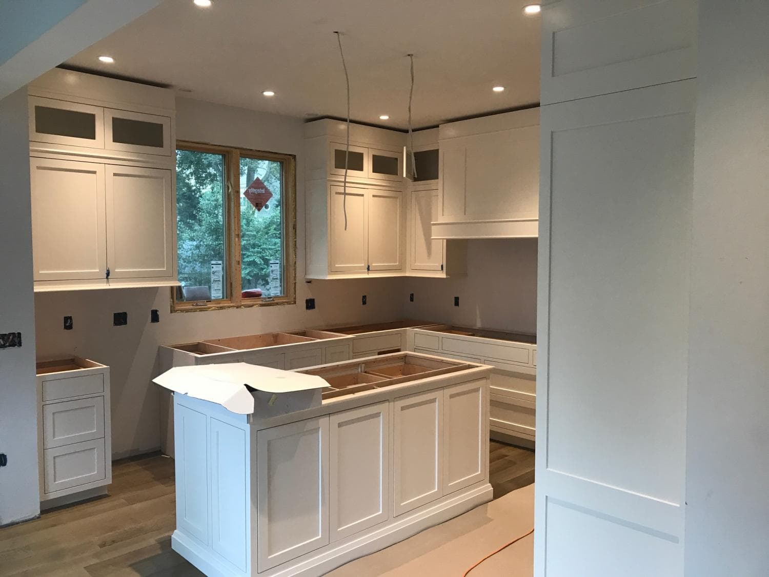 White kitchen with island, nearly finished