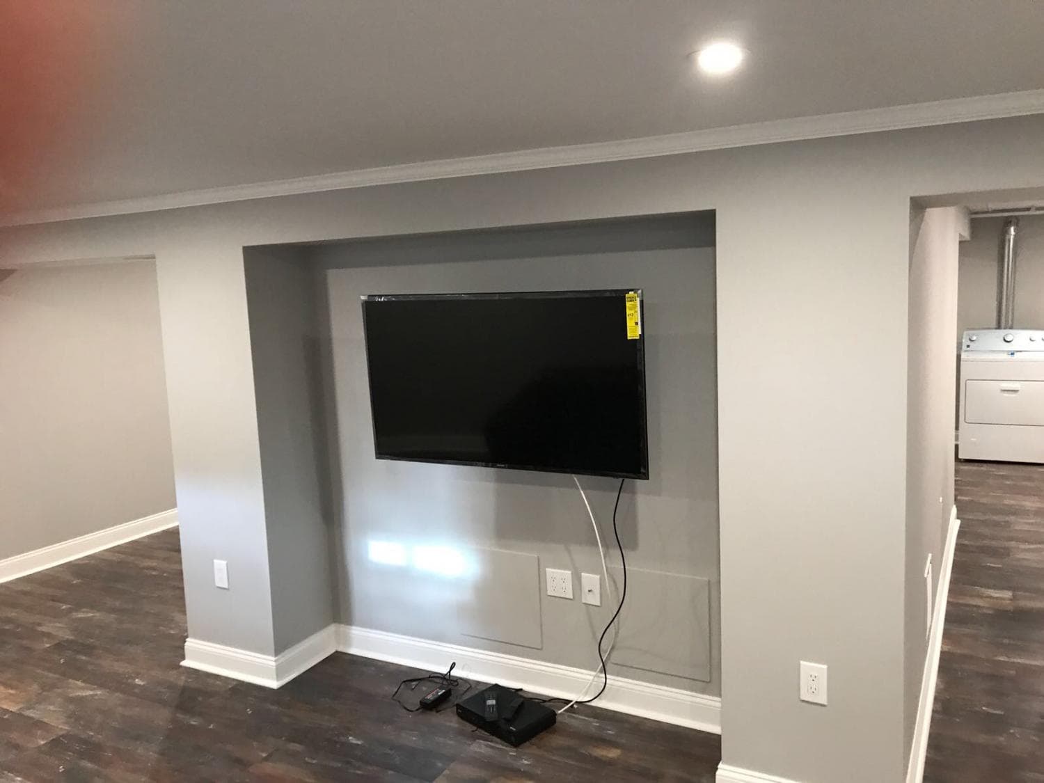 Finished basement family room with plank flooring and painted walls