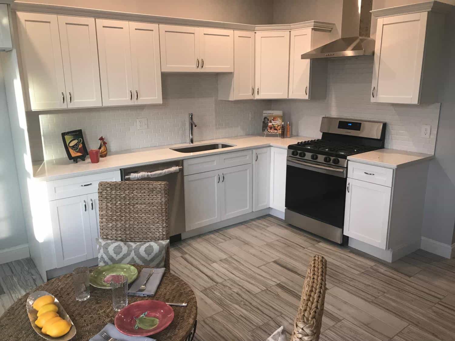 White shaker kitchen with plank tile floor