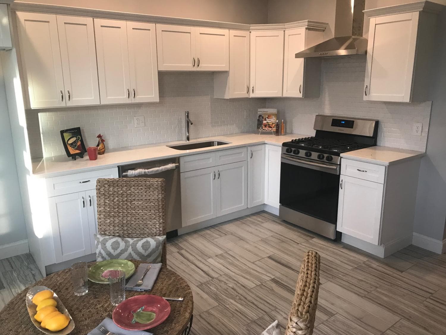 White shaker kitchen with plank tile floor