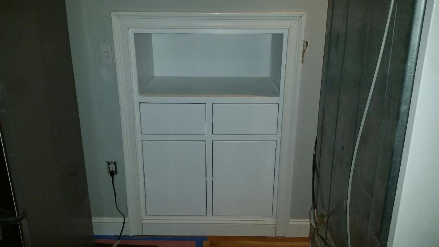 Painted built-in cabinet with an open shelf above