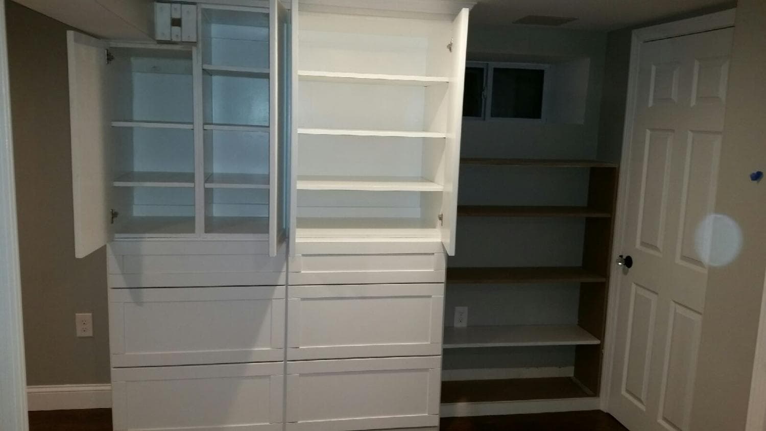 Custom built-in cabinets with glass-front uppers and drawers