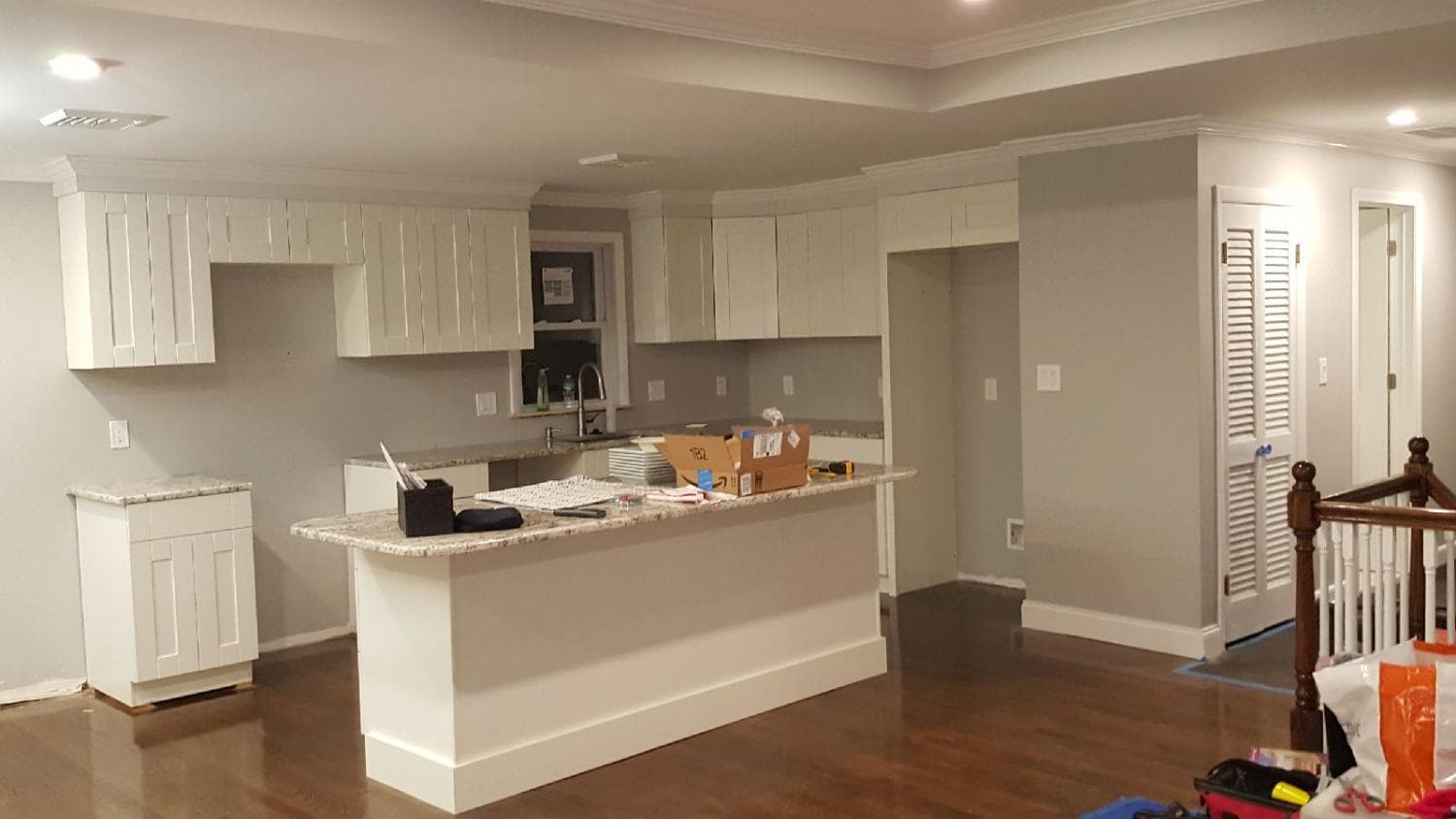 White kitchen with island open to the living area