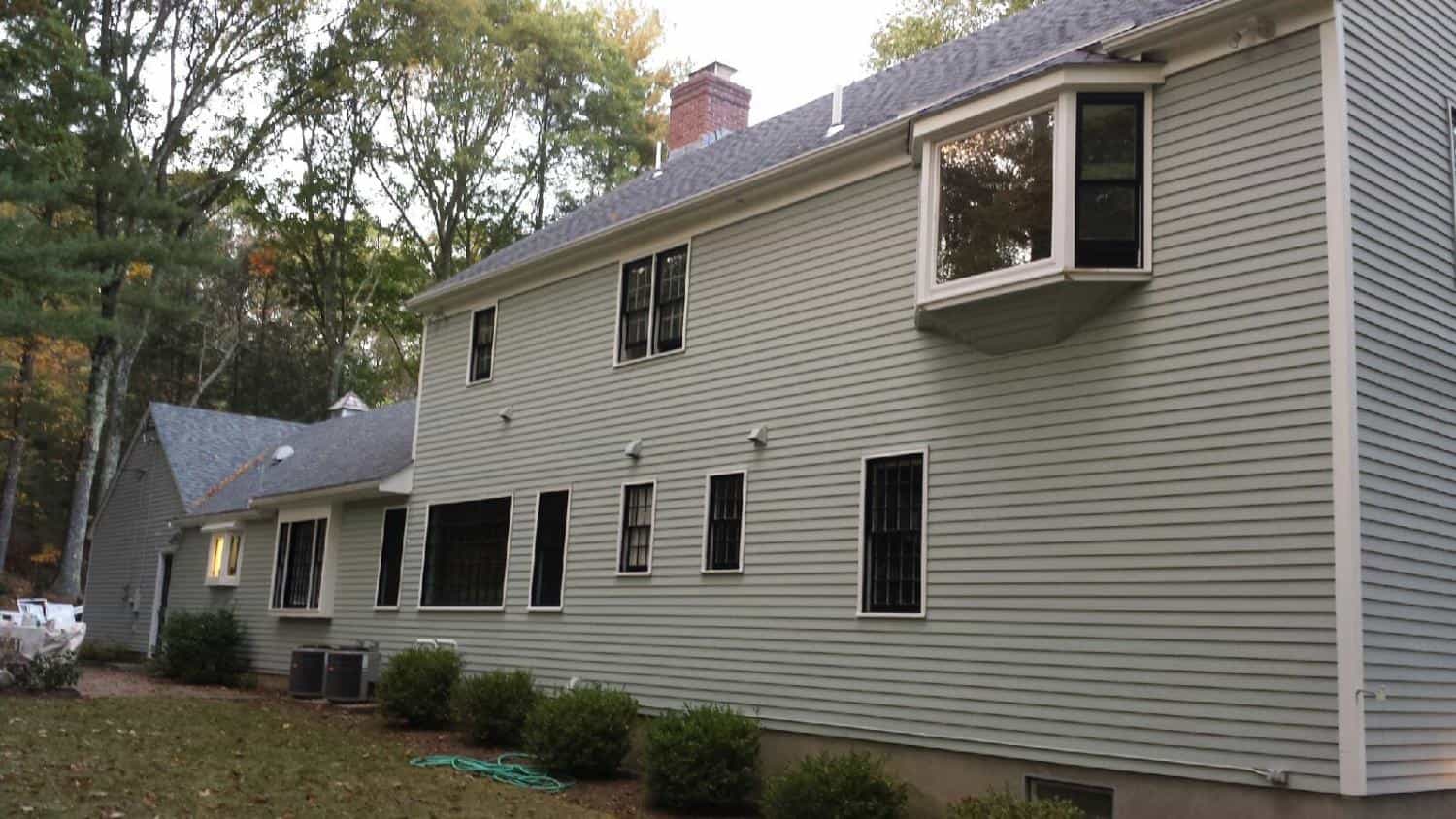 Two-story colonial with freshly painted gray siding