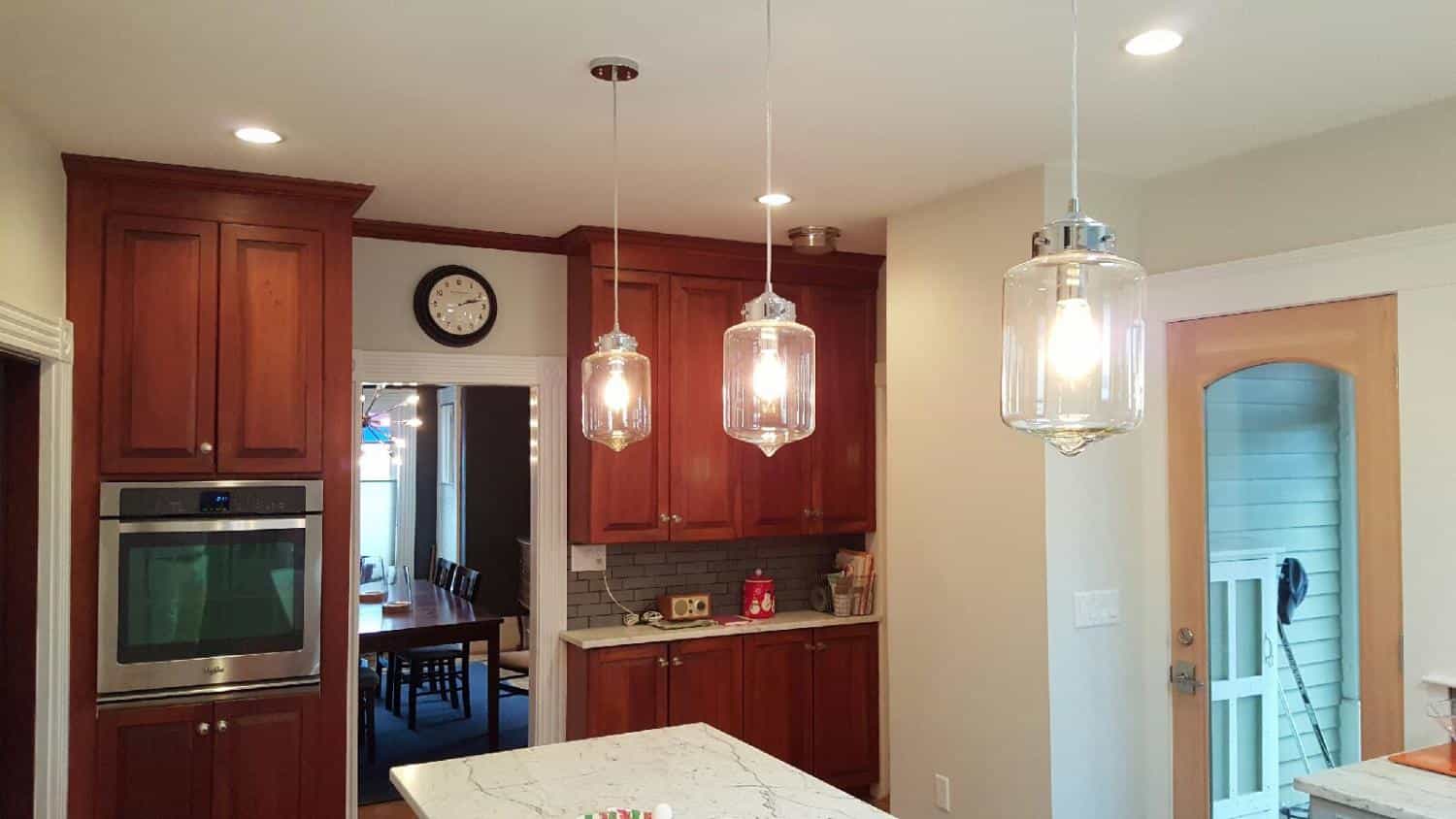 Kitchen with cherry cabinets and pendant lights