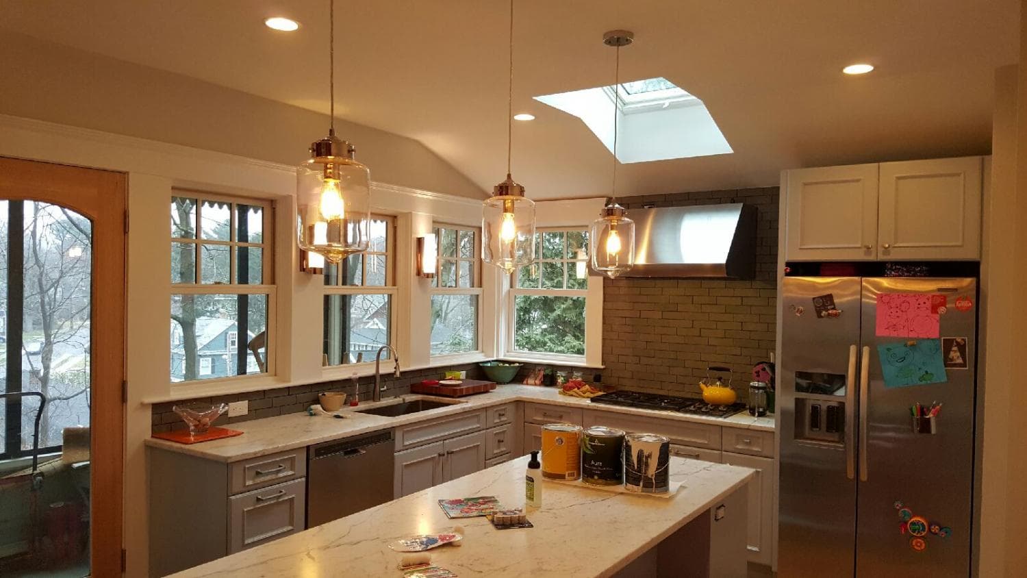 Kitchen with skylight, island and pendant lights