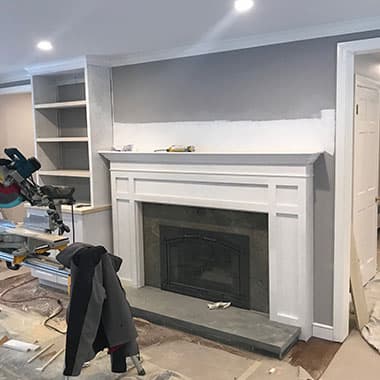 New fireplace mantel with built-in shelves on both sides
