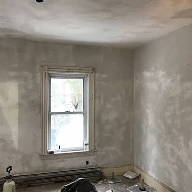 Room with wallpaper removed and the walls skim coated